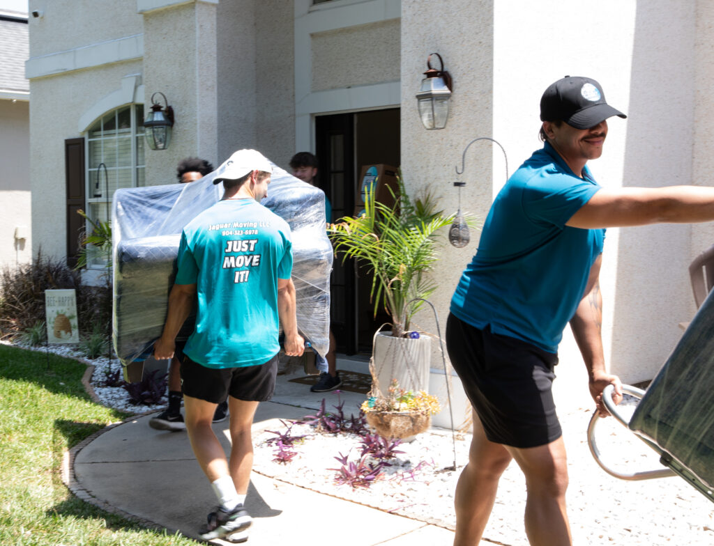 Professional movers from Jaguar Moving loading boxes into a moving truck in Jacksonville, FL